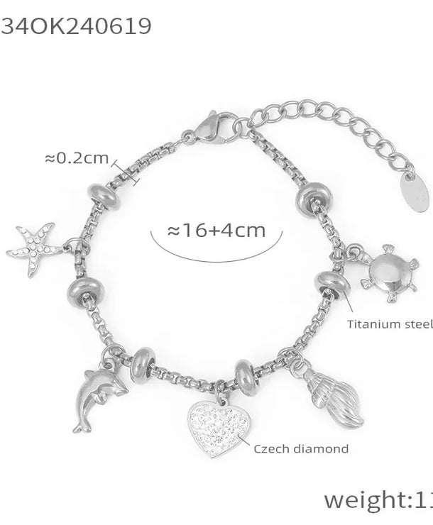Pulsera de acero 304 con baño de oro 18K y dijes de cruz, estrella y corazón - imagen 12