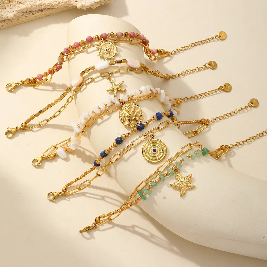 Pulsera de acero 304 con dijes de estrella de mar, corazón y concha
