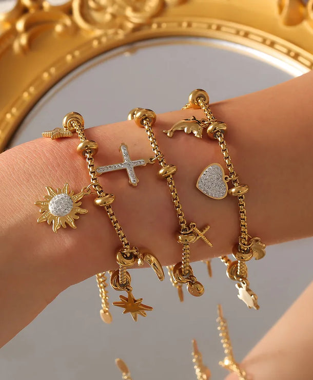 Pulsera de acero 304 con baño de oro 18K y dijes de cruz, estrella y corazón